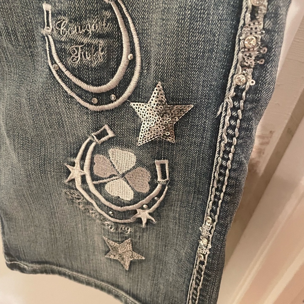 Blue Jeans with Decorative Embellishments and Contrast Stitching